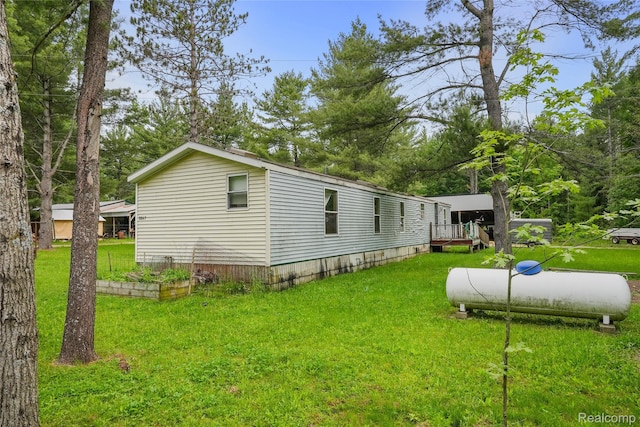 8875 N Lakola Rd, Tustin, MI 49688 - view of home's exterior featuring a yard