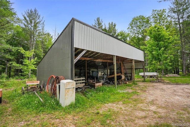 8875 N Lakola Rd, Tustin, MI 49688 - view of pole building featuring a carport