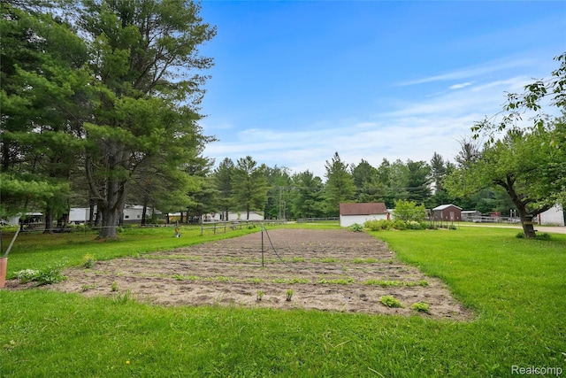 8875 N Lakola Rd, Tustin, MI 49688 - view of home's community featuring a lawn and an outdoor structure