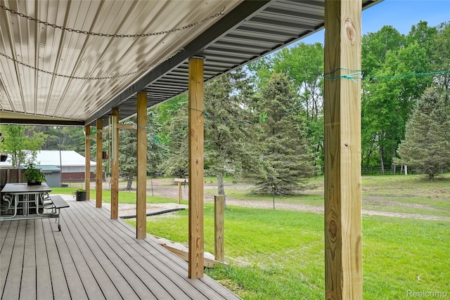8875 N Lakola Rd, Tustin, MI 49688 - wooden terrace with a yard and view of wooded area
