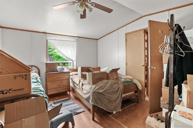 8875 N Lakola Rd, Tustin, MI 49688 - bedroom with vaulted ceiling, wood finished floors, a ceiling fan, and ornamental molding