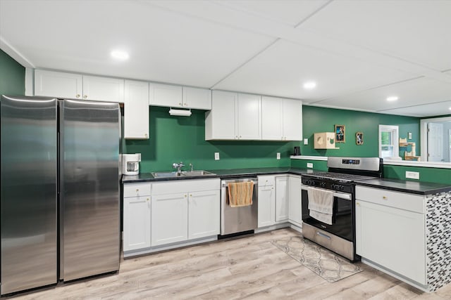 3701 3 1/2 Mile Rd, Athens, MI 49011 - kitchen with stainless steel appliances, a sink, a peninsula, dark countertops, and white cabinets