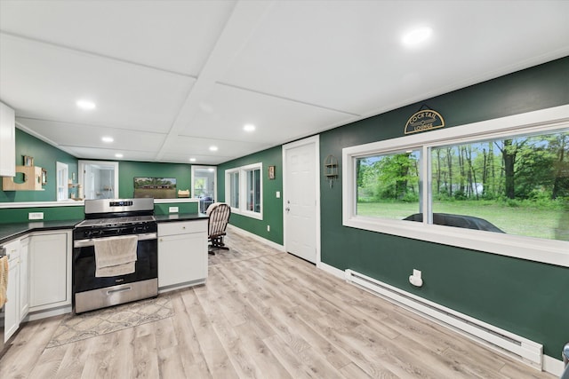 3701 3 1/2 Mile Rd, Athens, MI 49011 - kitchen with stainless steel gas range oven, a baseboard heating unit, dark countertops, light wood finished floors, and recessed lighting