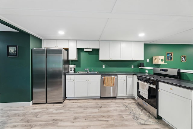 3701 3 1/2 Mile Rd, Athens, MI 49011 - kitchen with appliances with stainless steel finishes, a sink, dark countertops, white cabinetry, and recessed lighting