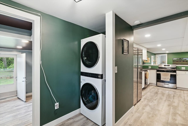 3701 3 1/2 Mile Rd, Athens, MI 49011 - washroom featuring stacked washer / dryer, light wood-type flooring, recessed lighting, and baseboards