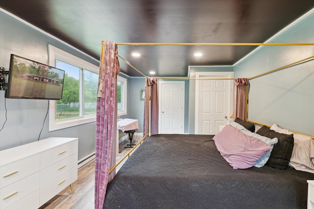3701 3 1/2 Mile Rd, Athens, MI 49011 - bedroom featuring wood finished floors, recessed lighting, and baseboard heating