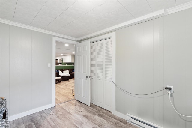 3701 3 1/2 Mile Rd, Athens, MI 49011 - unfurnished bedroom featuring a baseboard radiator, light wood finished floors, crown molding, and a closet