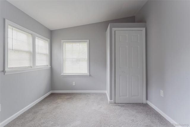 38204 Main St, New Baltimore, MI 48047 - unfurnished bedroom with vaulted ceiling, carpet floors, and baseboards