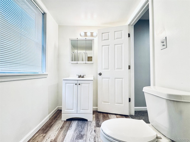 38204 Main St, New Baltimore, MI 48047 - bathroom with vanity, wood finished floors, baseboards, and toilet