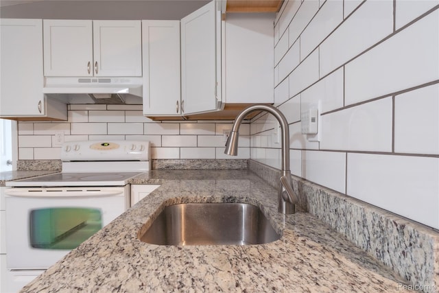 38204 Main St, New Baltimore, MI 48047 - kitchen with white range with electric stovetop, a sink, under cabinet range hood, and white cabinets