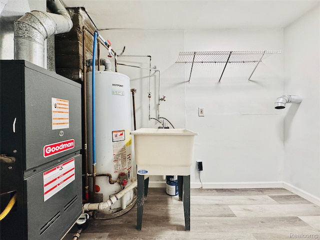 38204 Main St, New Baltimore, MI 48047 - utility room with gas water heater, heating unit, and a sink