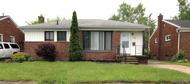 26471 Marshall St, Inkster, MI 48141 - bungalow-style house with brick siding, a front lawn, a chimney, and board and batten siding