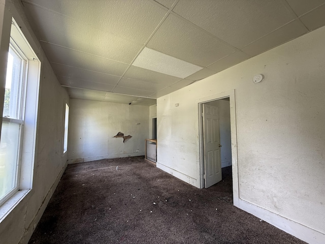 391 Monroe Ave, Muskegon, MI 49441 - unfurnished room with a drop ceiling, healthy amount of natural light, carpet floors, a smoke detector, and baseboards