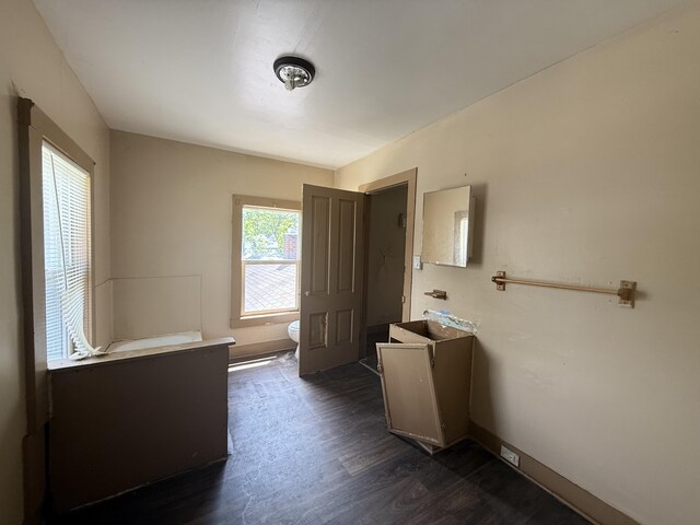 391 Monroe Ave, Muskegon, MI 49441 - full bathroom with vanity, toilet, wood finished floors, and baseboards