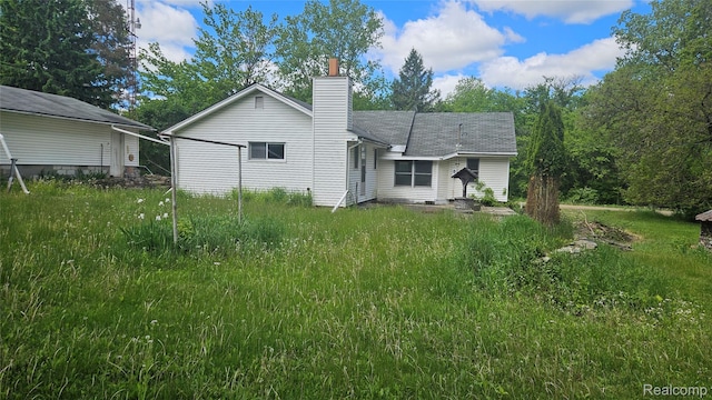 5820 Mack Rd, Howell, MI 48855 - back of property with a chimney