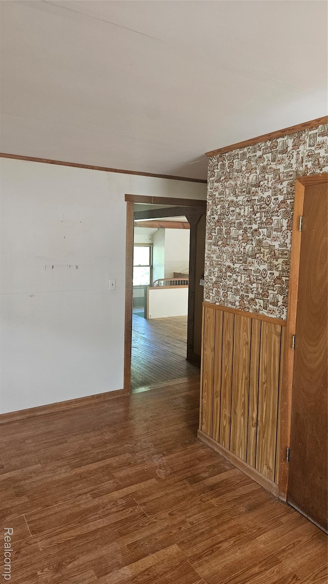 5820 Mack Rd, Howell, MI 48855 - spare room featuring wood finished floors, wood walls, and crown molding