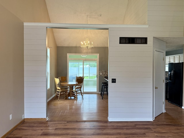 6981 Jennifer Ln, Portland, MI 48875 - dining area featuring a chandelier, dark wood finished floors, and baseboards