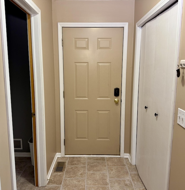 6981 Jennifer Ln, Portland, MI 48875 - doorway to outside featuring baseboards