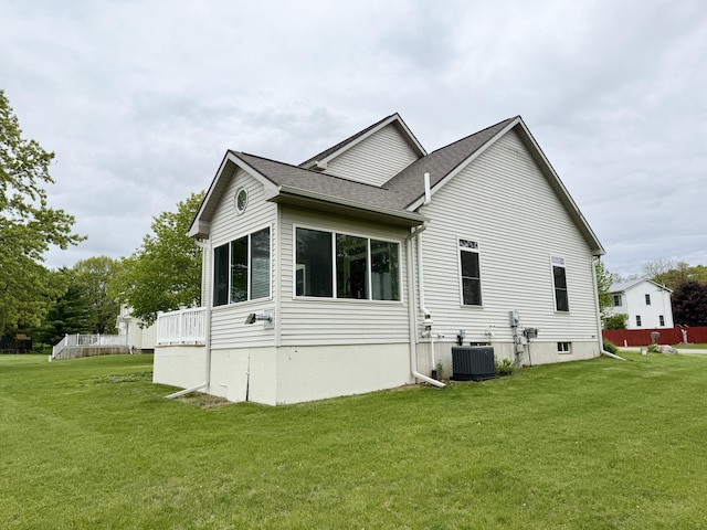 6981 Jennifer Ln, Portland, MI 48875 - view of property exterior featuring cooling unit, a lawn, and a shingled roof