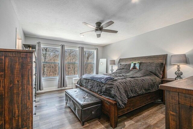 18734 Leonard Ct, New Buffalo, MI 49117 - bedroom featuring wood finished floors, a textured ceiling, and a ceiling fan