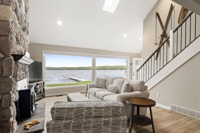 5384 Indian Trl, Frankfort, MI 49635 - living room with light wood-type flooring, plenty of natural light, stairs, recessed lighting, and high vaulted ceiling