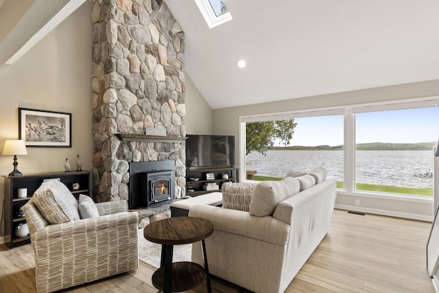 5384 Indian Trl, Frankfort, MI 49635 - living area with a skylight, wood finished floors, baseboards, and high vaulted ceiling