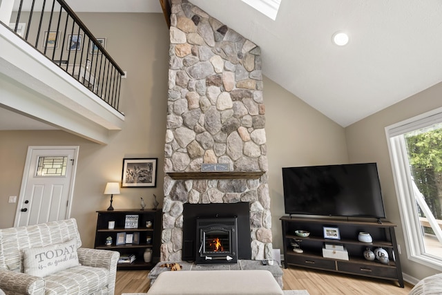 5384 Indian Trl, Frankfort, MI 49635 - living room with wood finished floors, a fireplace, high vaulted ceiling, and baseboards