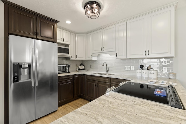 5384 Indian Trl, Frankfort, MI 49635 - kitchen with appliances with stainless steel finishes, a sink, dark brown cabinets, white cabinetry, and recessed lighting