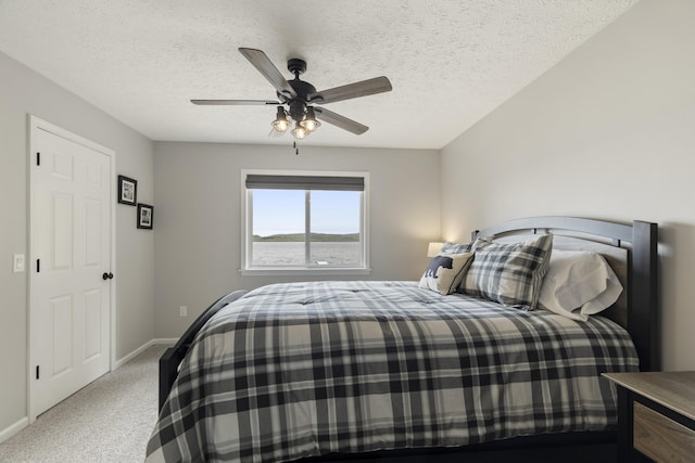 5384 Indian Trl, Frankfort, MI 49635 - carpeted bedroom with baseboards, a textured ceiling, and ceiling fan