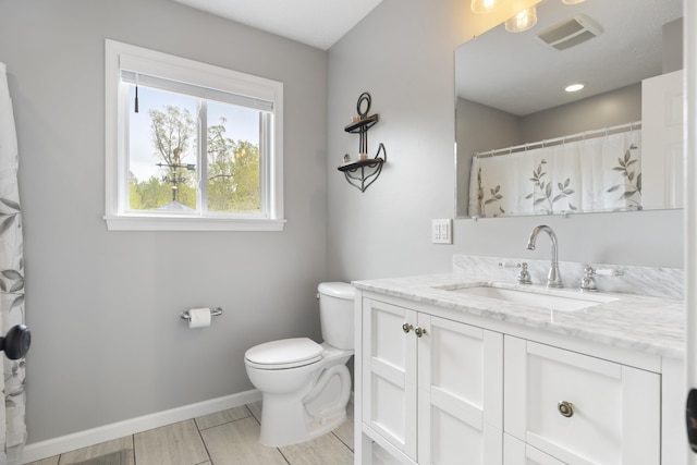 5384 Indian Trl, Frankfort, MI 49635 - full bathroom featuring baseboards, vanity, and toilet