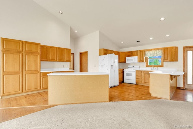5562 Sheridan Line Rd, Croswell, MI 48422 - kitchen with white appliances, high vaulted ceiling, light countertops, a peninsula, and recessed lighting