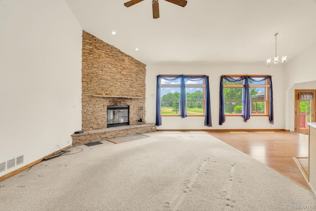5562 Sheridan Line Rd, Croswell, MI 48422 - unfurnished living room with high vaulted ceiling, a ceiling fan, a fireplace, wood finished floors, and a chandelier
