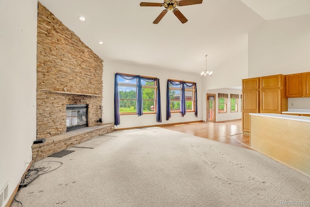 5562 Sheridan Line Rd, Croswell, MI 48422 - unfurnished living room featuring light colored carpet, high vaulted ceiling, ceiling fan, a stone fireplace, and a chandelier