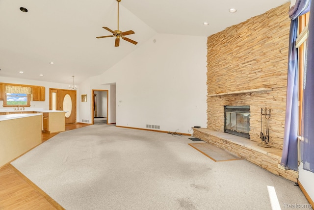 5562 Sheridan Line Rd, Croswell, MI 48422 - unfurnished living room featuring ceiling fan, a stone fireplace, high vaulted ceiling, and recessed lighting