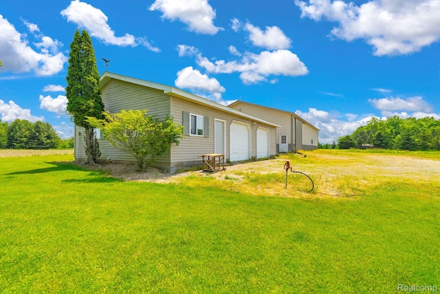 5562 Sheridan Line Rd, Croswell, MI 48422 - rear view of property featuring a yard and an attached garage