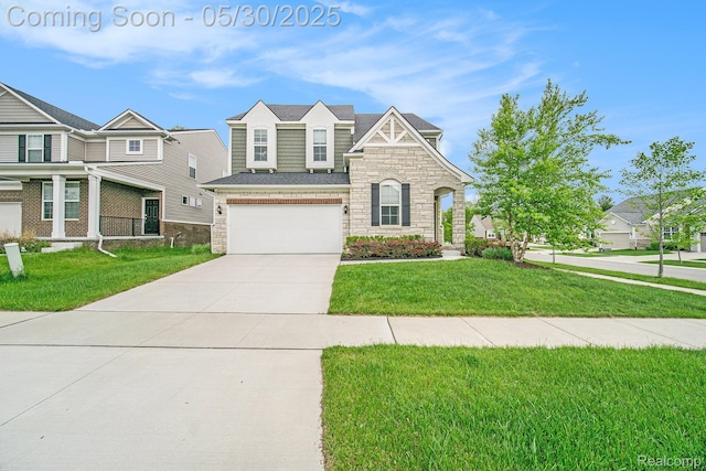 2979 Havre St, Ann Arbor, MI 48105 - view of front facade featuring stone siding, concrete driveway, an attached garage, and a front lawn