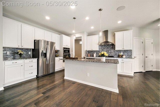 2979 Havre St, Ann Arbor, MI 48105 - kitchen featuring appliances with stainless steel finishes, wall chimney range hood, a sink, tasteful backsplash, and dark wood-style flooring