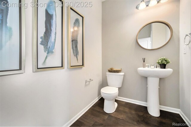 2979 Havre St, Ann Arbor, MI 48105 - half bath featuring toilet, wood finished floors, and baseboards