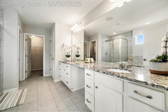 2979 Havre St, Ann Arbor, MI 48105 - full bath featuring a shower stall, vanity, a walk in closet, tile patterned floors, and baseboards