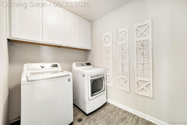 2979 Havre St, Ann Arbor, MI 48105 - laundry area with cabinet space, independent washer and dryer, wood finished floors, and baseboards