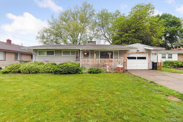 3307 Mackin Rd, Flint, MI 48504 - ranch-style home featuring covered porch, a front lawn, a garage, and driveway