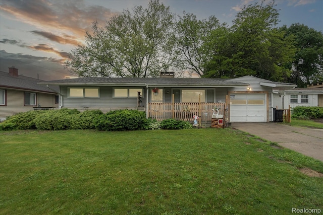 3307 Mackin Rd, Flint, MI 48504 - single story home featuring a porch, a yard, a garage, and driveway