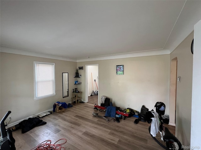 11106 Nottingham Rd, Detroit, MI 48224 - workout area featuring arched walkways, wood finished floors, baseboards, and ornamental molding