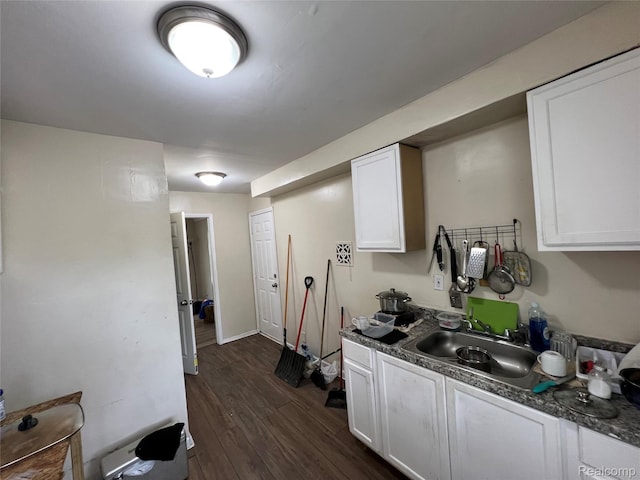 11106 Nottingham Rd, Detroit, MI 48224 - kitchen featuring dark wood-style floors, white cabinets, a sink, and dark countertops