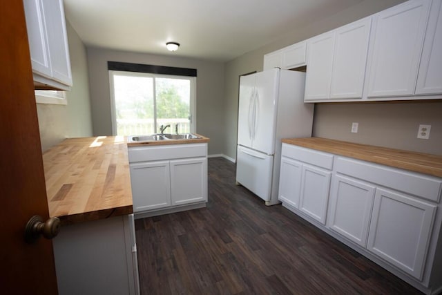 1429 Vine St, Lansing, MI 48912 - kitchen with wooden counters, freestanding refrigerator, a sink, dark wood-style floors, and white cabinetry