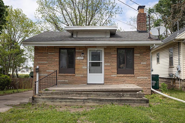 1429 Vine St, Lansing, MI 48912 - view of front of house with roof with shingles and a chimney