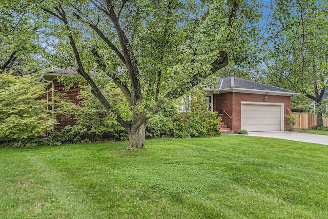 135 Barton Dr, Ann Arbor, MI 48105 - view of yard with an attached garage and concrete driveway