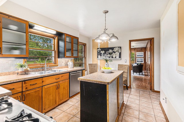 135 Barton Dr, Ann Arbor, MI 48105 - kitchen with stainless steel dishwasher, a sink, a kitchen island, and plenty of natural light
