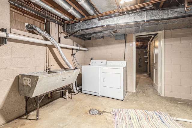 135 Barton Dr, Ann Arbor, MI 48105 - unfinished below grade area featuring washing machine and clothes dryer and a sink