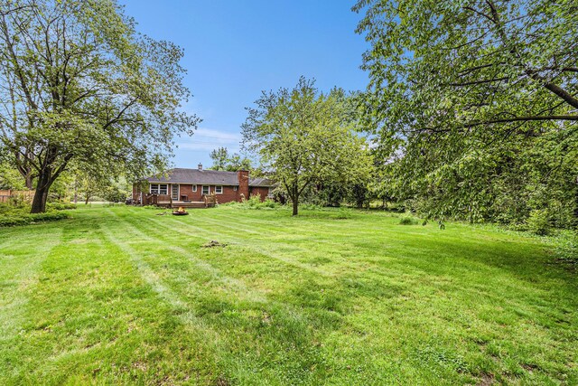 135 Barton Dr, Ann Arbor, MI 48105 - view of green lawn featuring a wooden deck